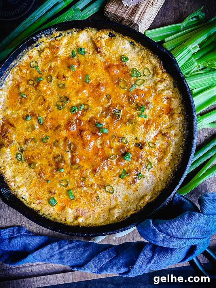 smoked chicken buffalo dip sprinkled with green onions and ready to eat