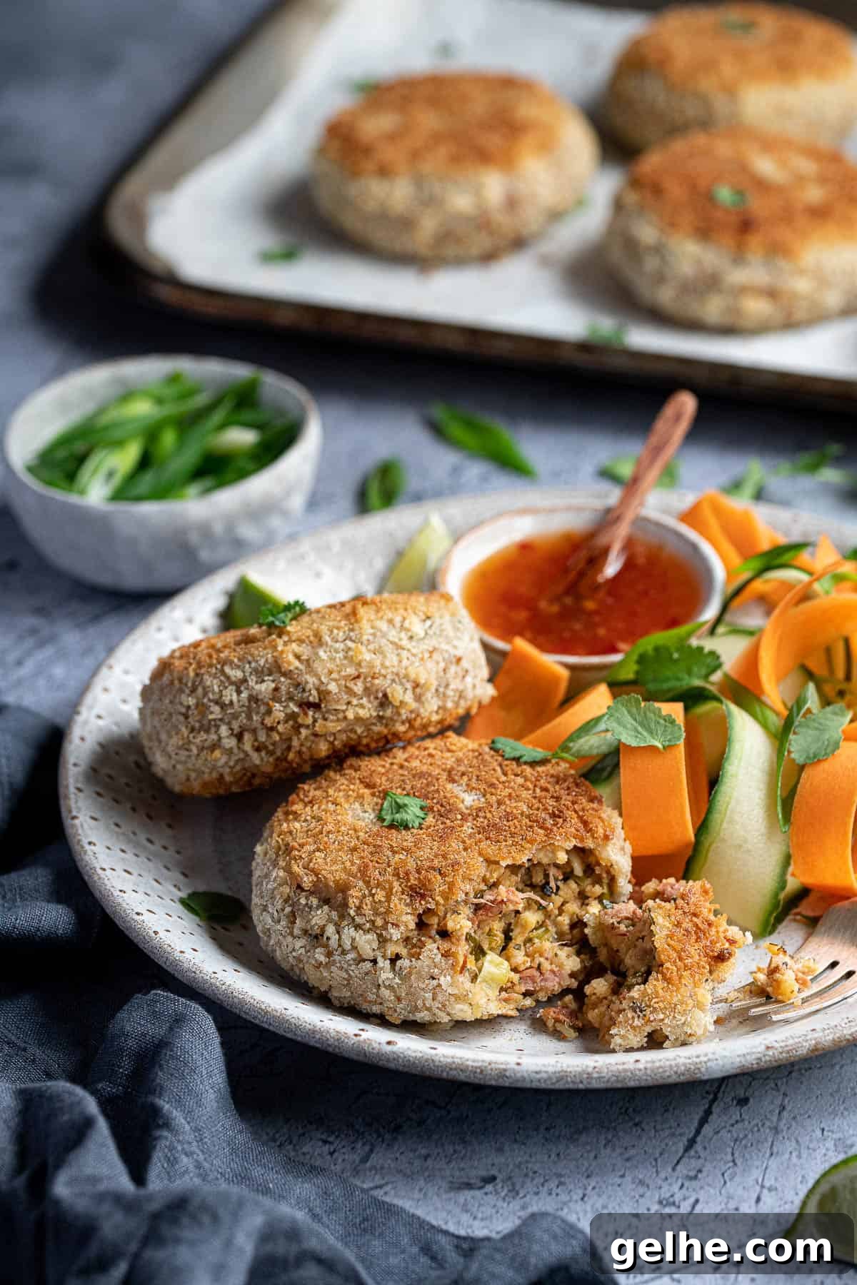 Close up of a vegan Thai red curry 'fish' cake with a forkful removed.