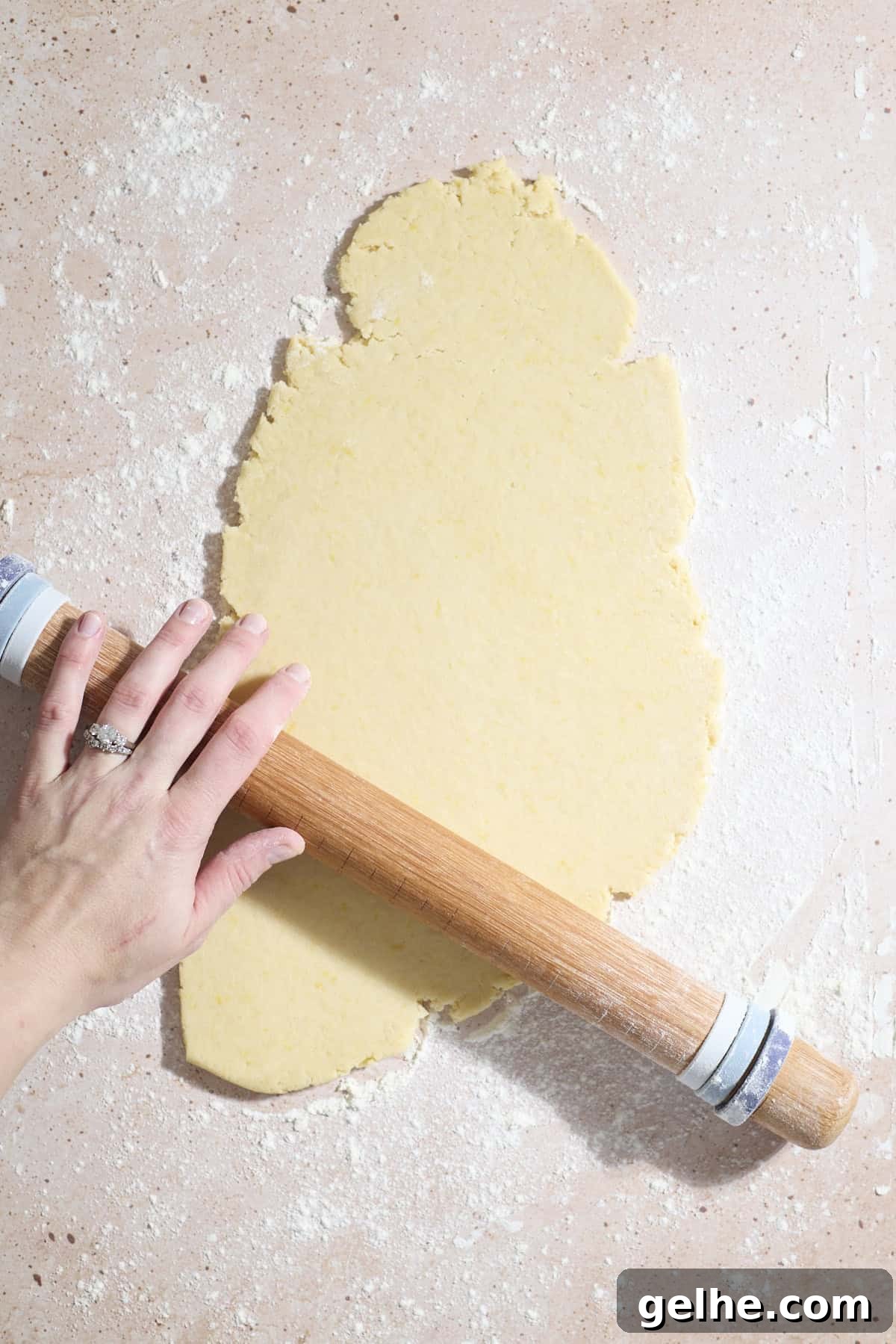 Lemon Sugar Cookies Made with Sourdough Discard 9 A hand rolling the dough with a rolling pin.