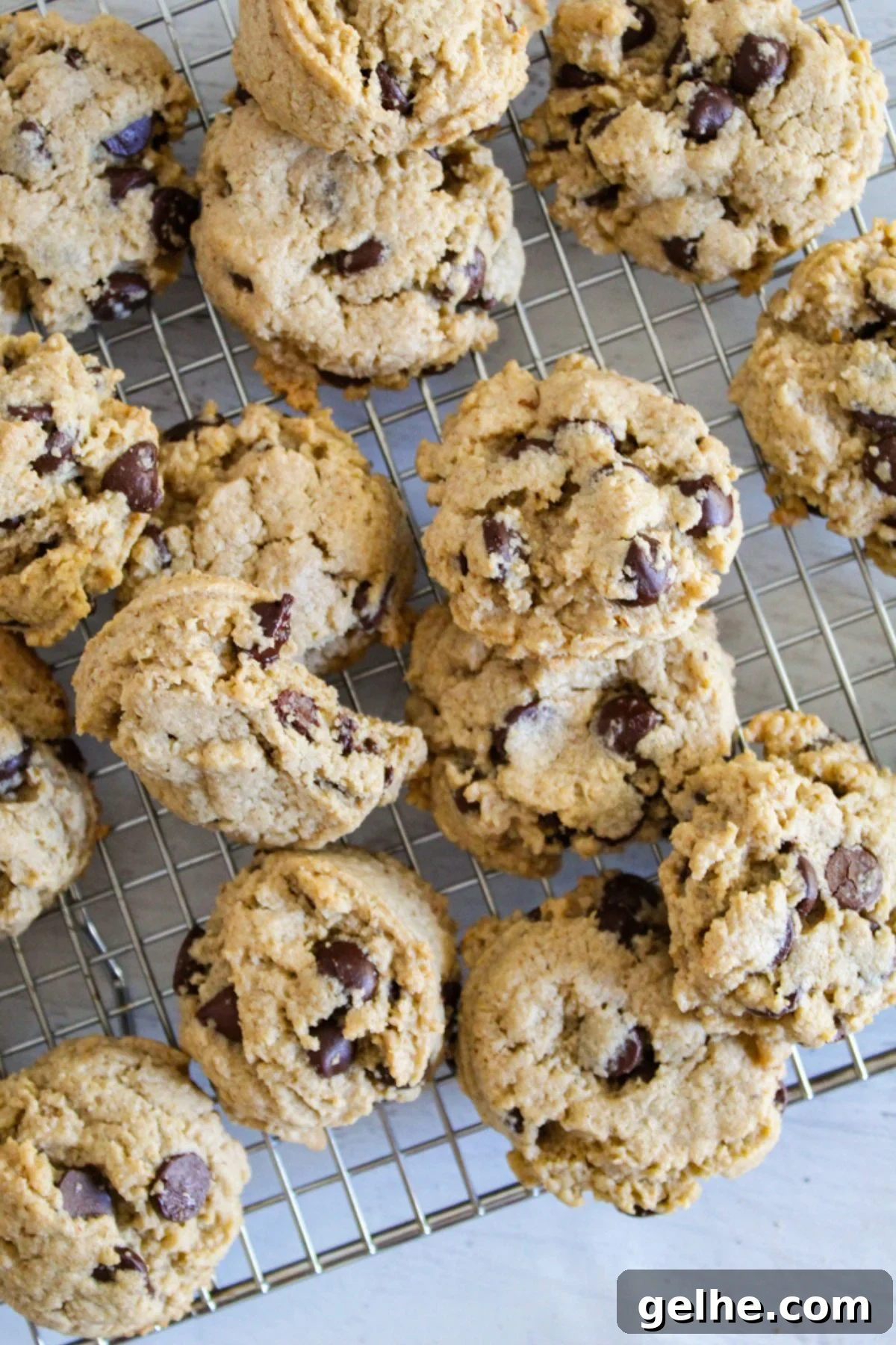 Oatmeal Flour Chocolate Chip Cookies: Secret to Soft, Chewy Texture 2 baked cookies on a wire rack
