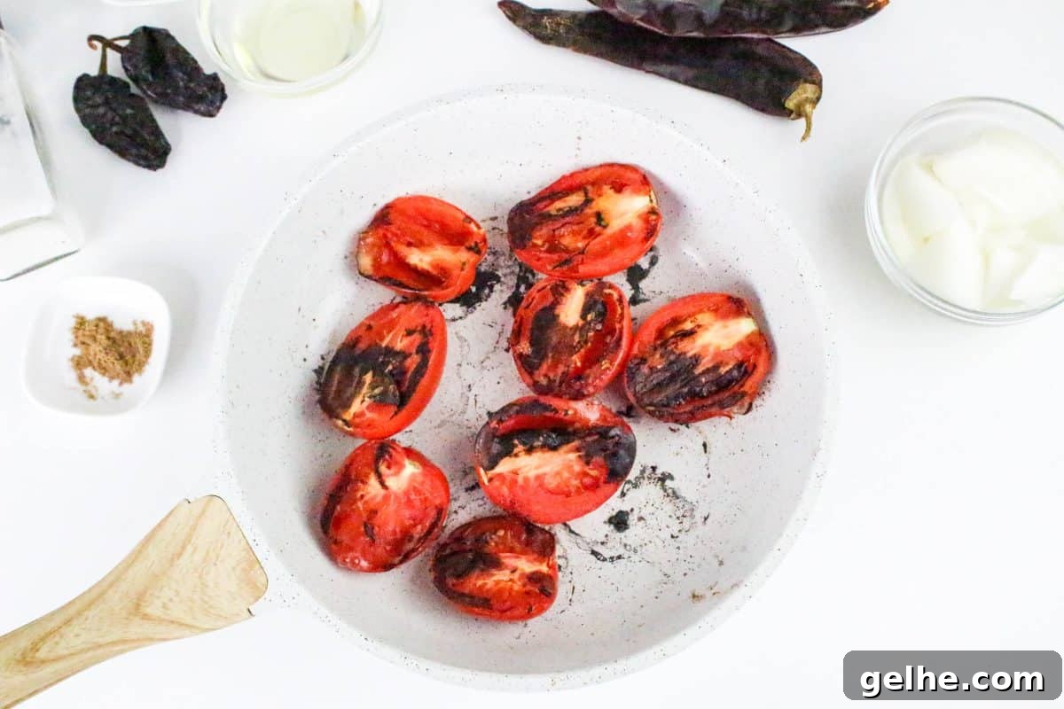 Authentic Red Salsa Roja with Dried Chiles Recipe 4 Top down view of roasted roma tomatoes - Hostess At Heart