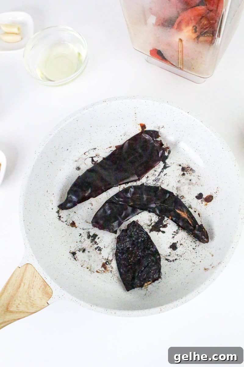 Authentic Red Salsa Roja with Dried Chiles Recipe 5 A plate holding dried and roasted chilies - Hostess At Heart