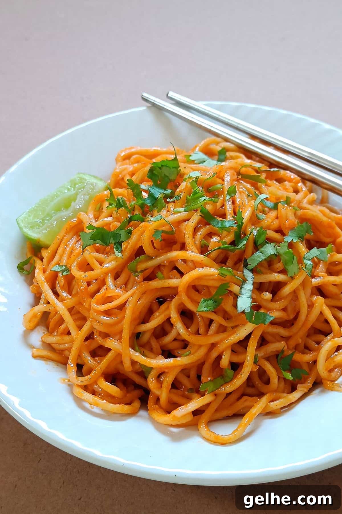 Gochujang buttered noodles served on a white plate.