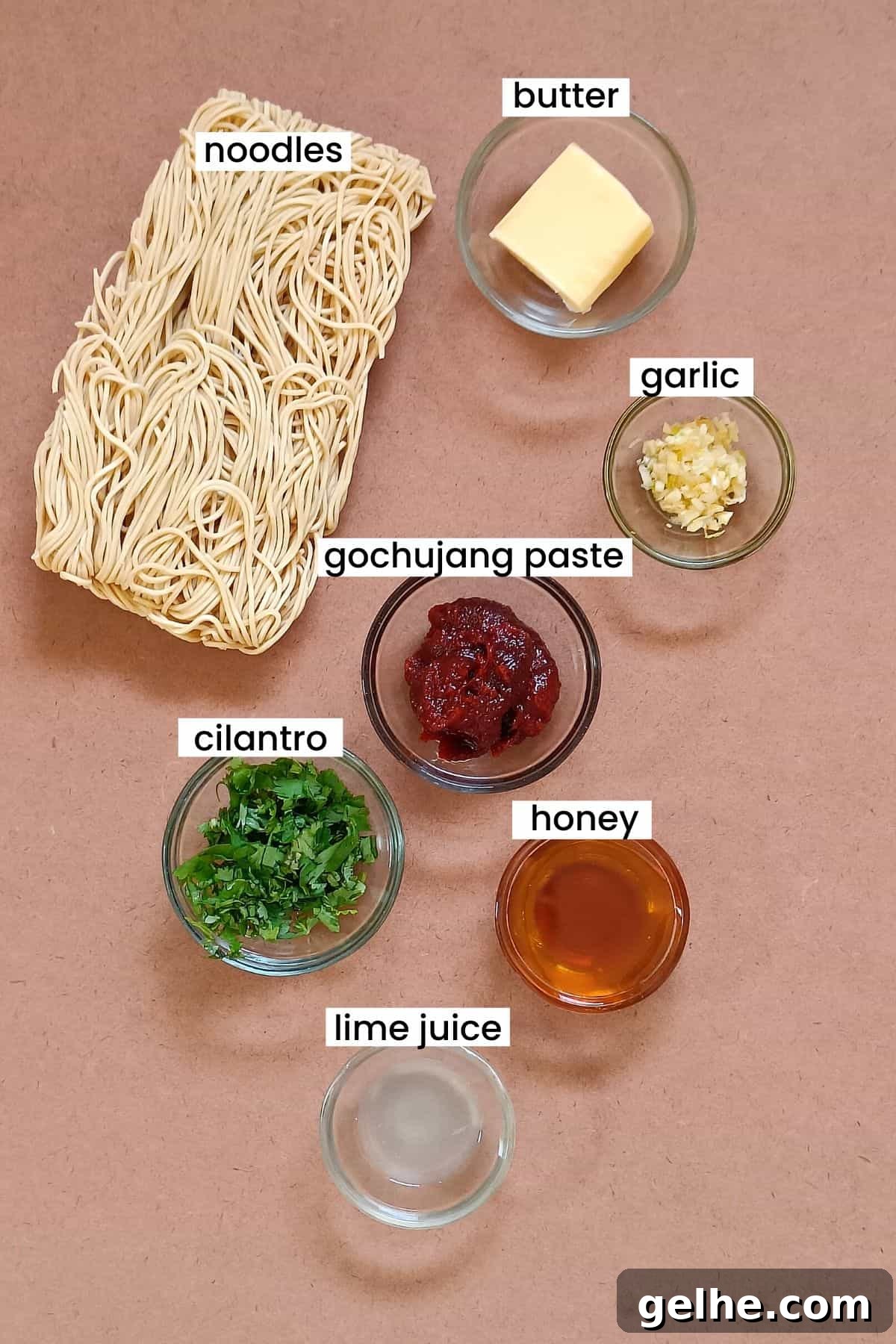 Gochujang buttered noodles recipe ingredients placed on an earthy background.