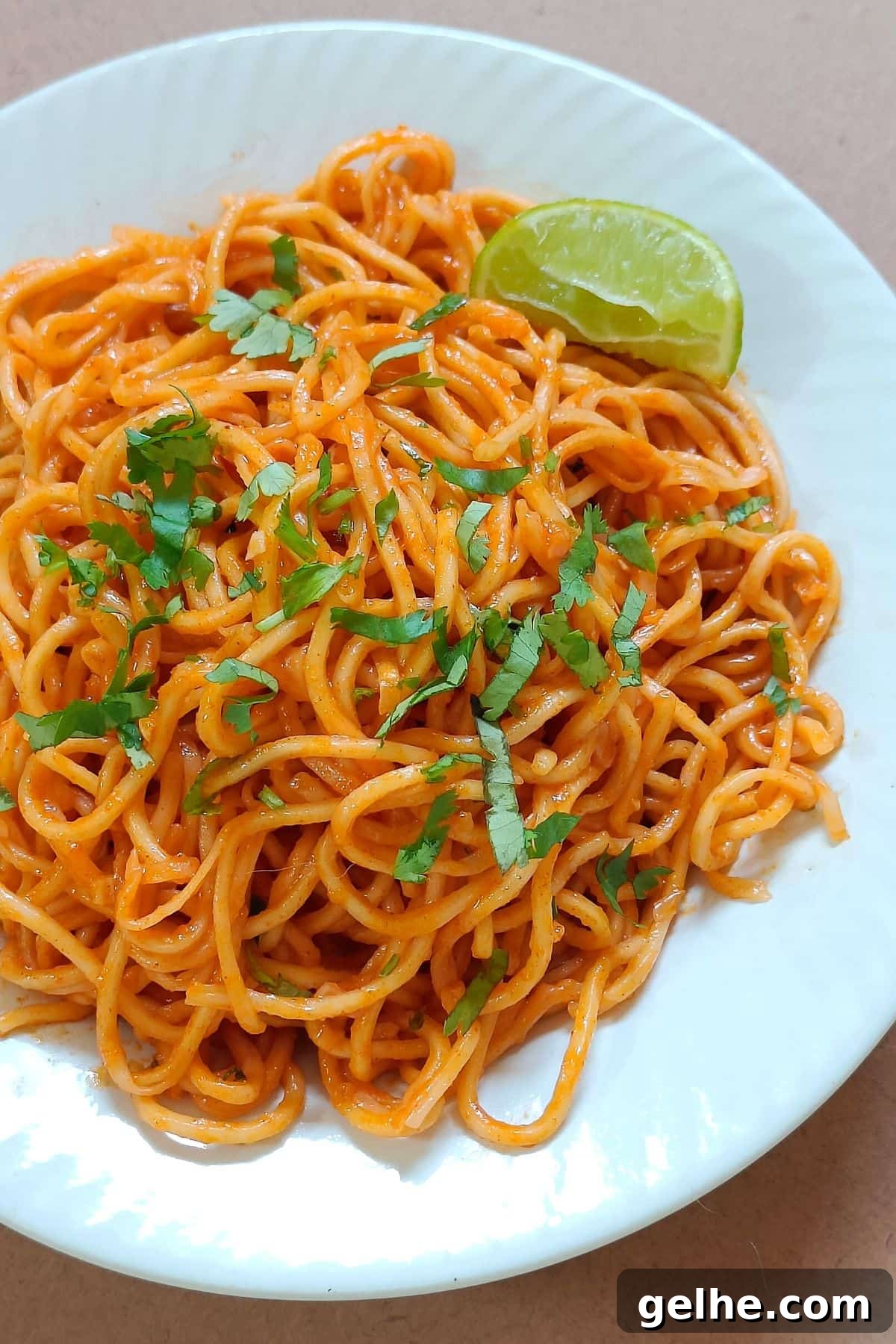 Gochujang butter noodles served on a white plate.