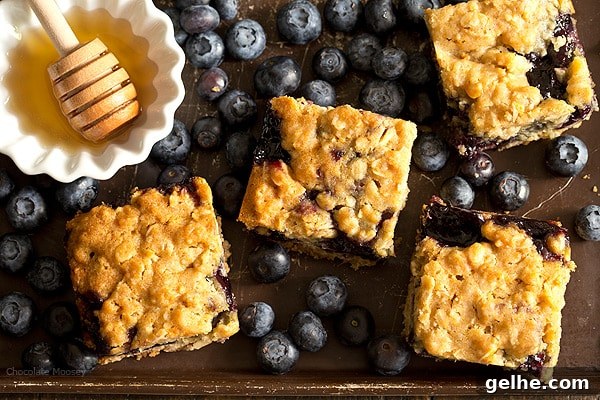 Soft, moist, and reminiscent of oatmeal cookies, Honey Blueberry Oatmeal Bars are filled with a homemade blueberry honey jam without pectin.