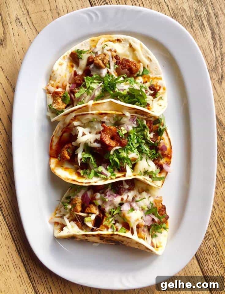 3 Tacos al Pastor from Hispanic Mama on a long oval white platter.