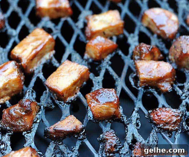 Cranberry Barbecue Turkey Burnt Ends Recipe 3 sauced turkey burnt ends on grill.