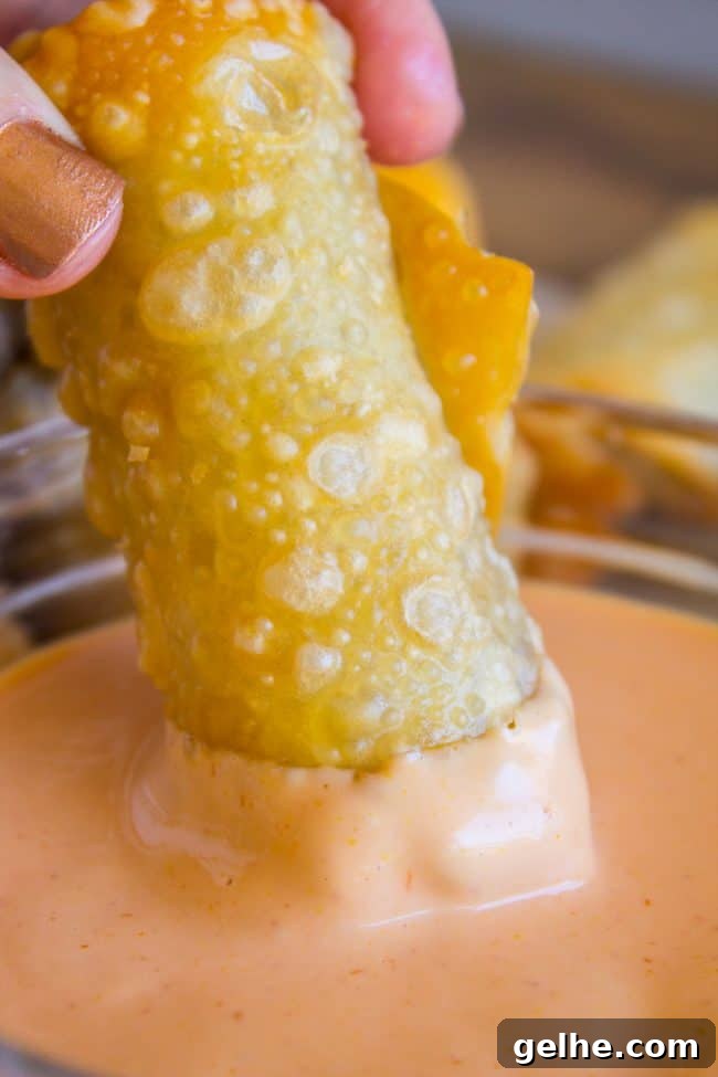 dipping a cheeseburger egg roll in fry sauce.