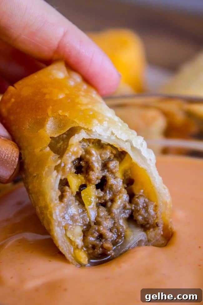 dipping a cheeseburger egg roll in fry sauce.