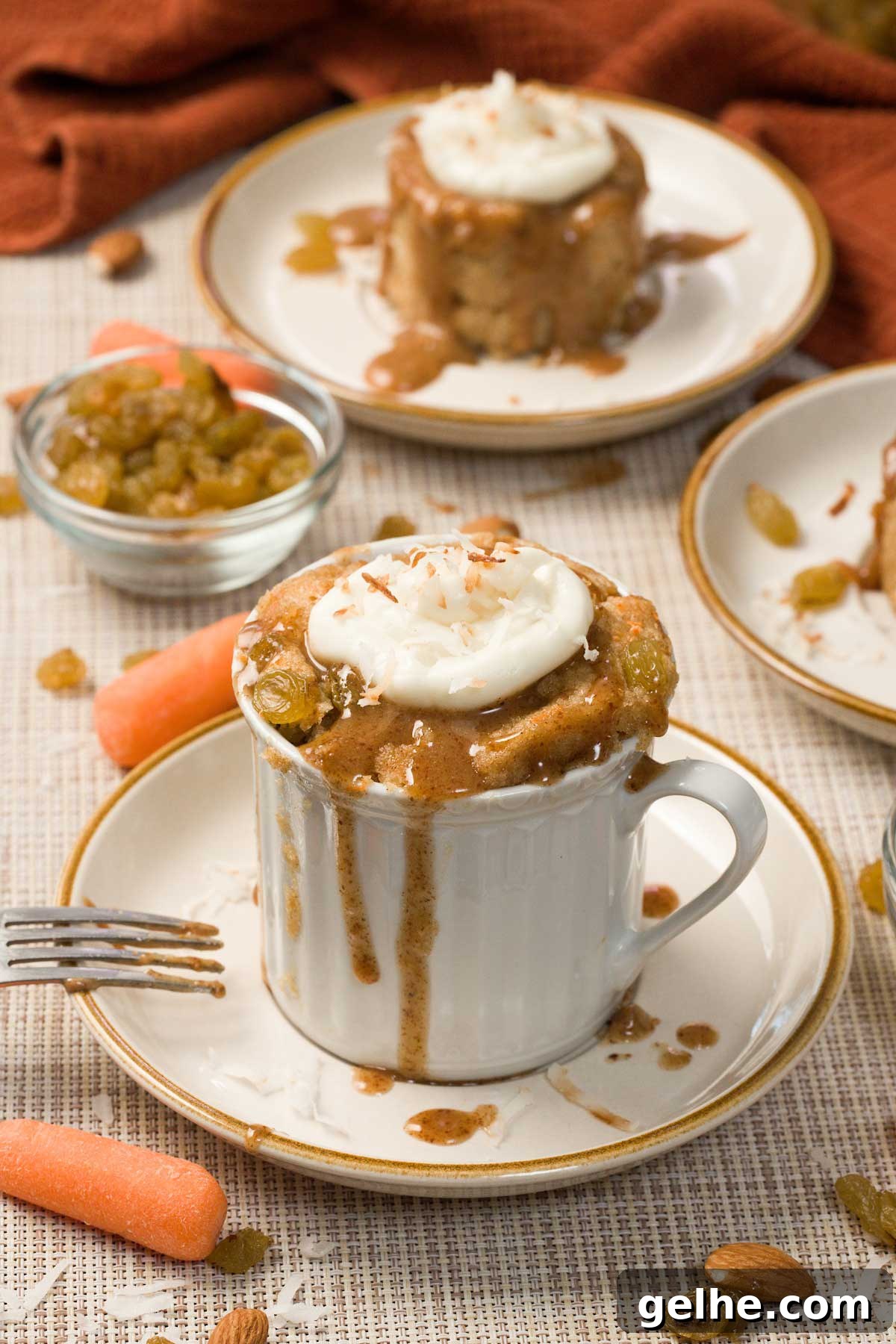 Carrot cake mug cake topped with almond butter caramel and cream cheese frosting.