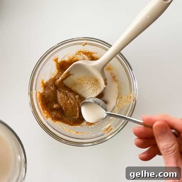 Adding milk to the almond butter caramel.