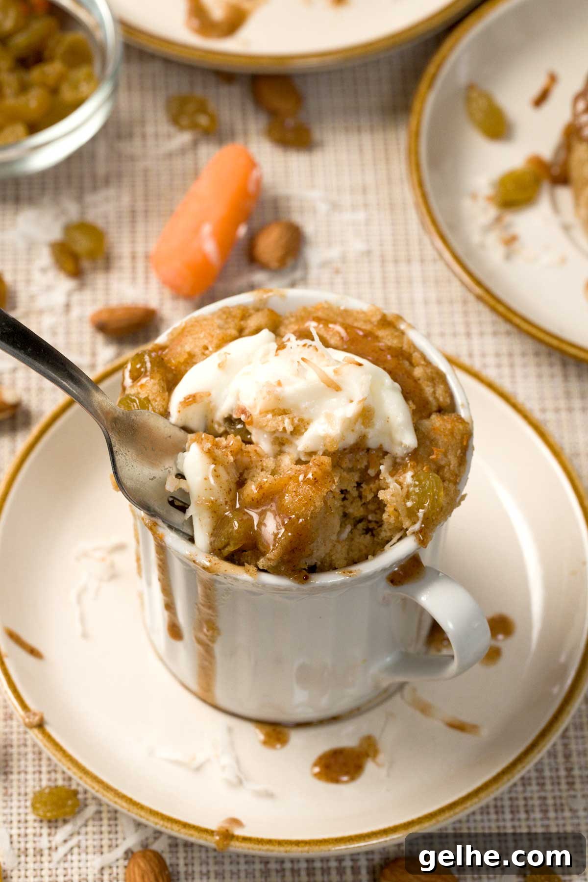 Carrot cake mug cake topped with almond butter caramel and cream cheese frosting.