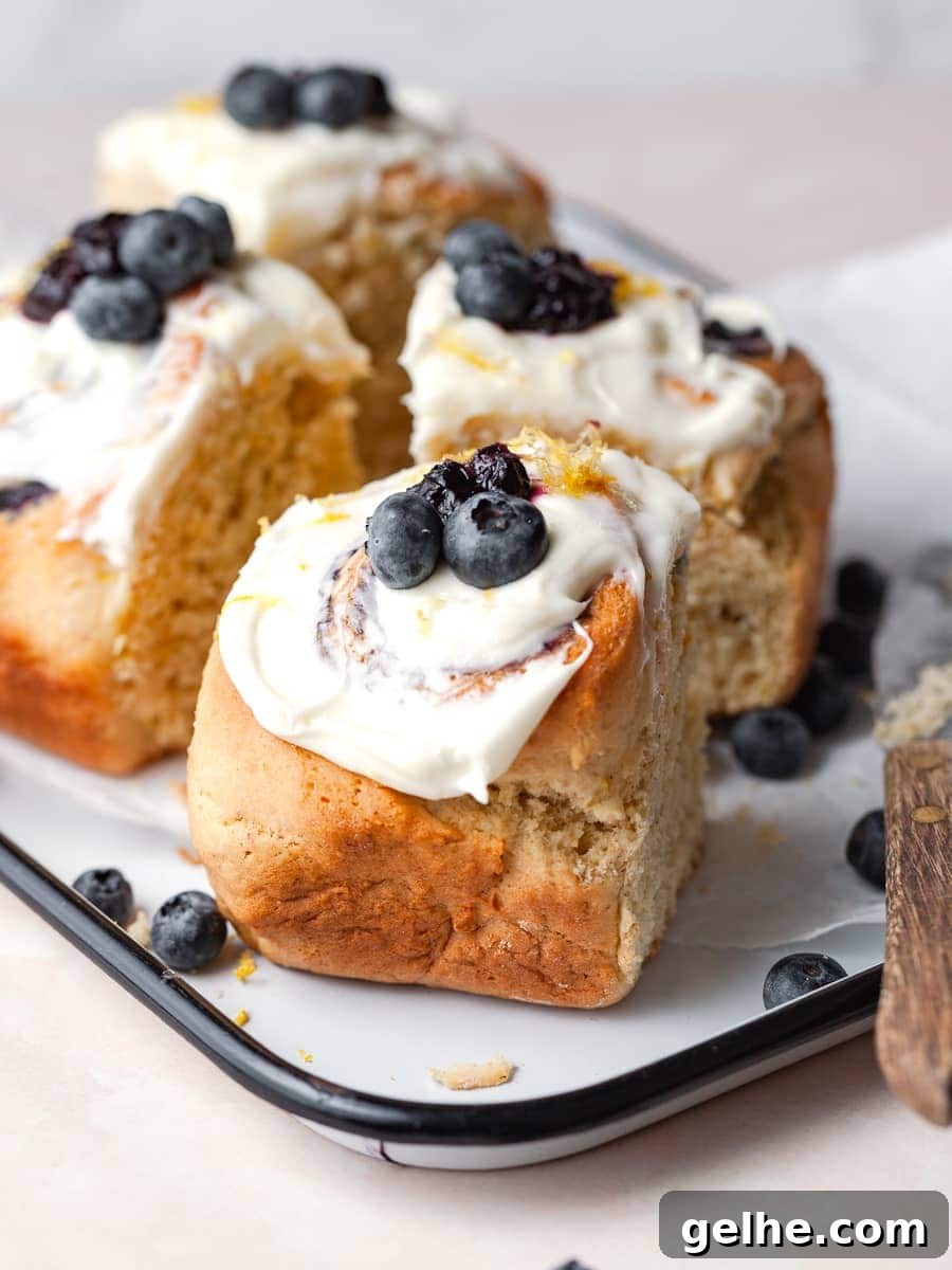 Gluten-Free Blueberry Sweet Rolls Recipe for Soft, Fluffy Buns 10 gluten free blueberry cinnamon rolls topped with lemon cream cheese frosting and fresh blueberries and lemon zest, blueberry sweet rolls