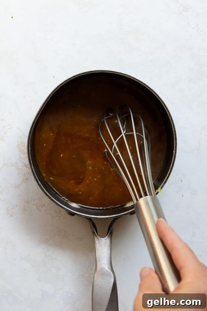 whisking homemade healthy teriyaki sauce in a sauce pan