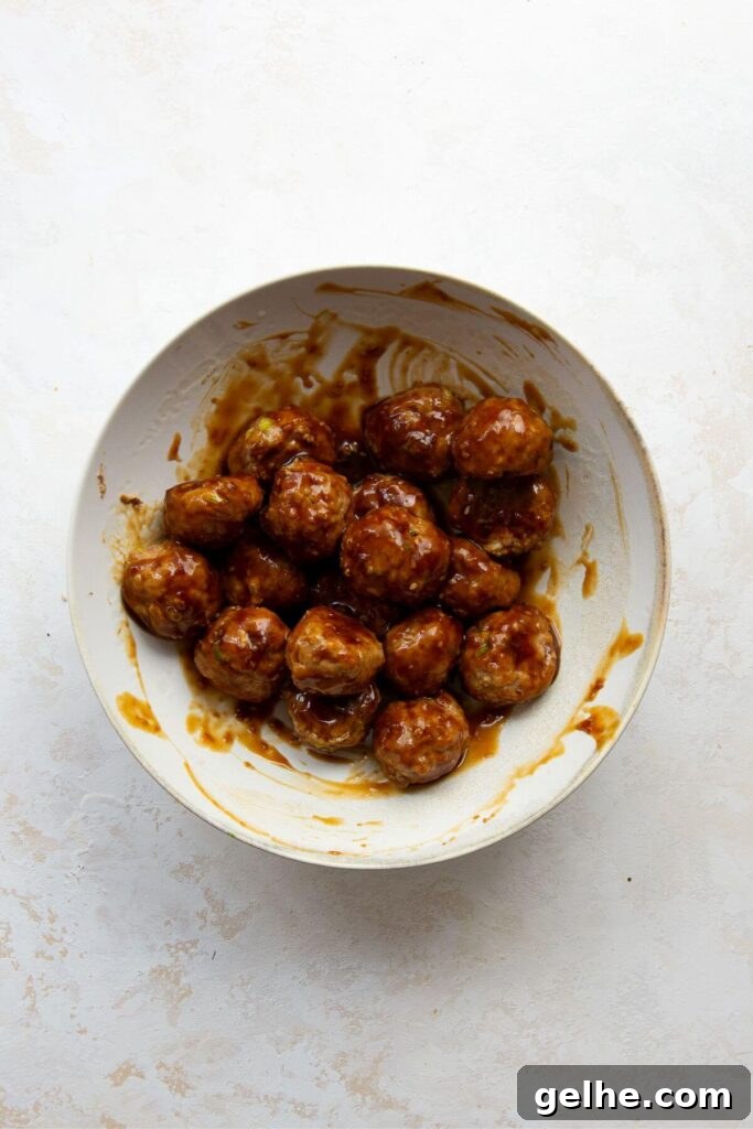 coating asian turkey meatballs in healthy teriyaki sauce