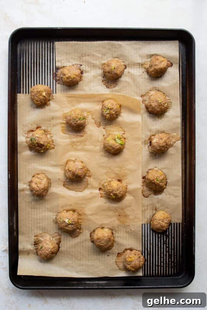 cooked meatballs on a baking sheet