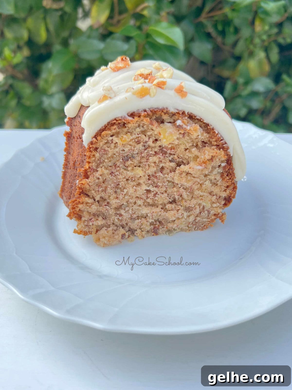 Slice of Hummingbird Bundt Cake on a white plate