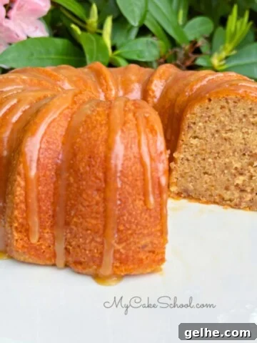 Banana Pecan Bundt Cake, sliced, on a cake pedestal.
