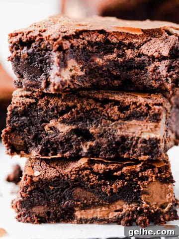 straight ahead super close-up of 3 chocolate brownies stacked on top of each other