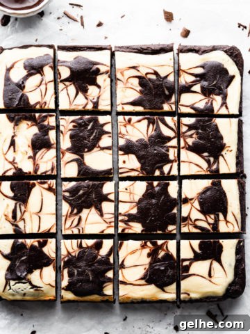 overhead shot of cheesecake topped brownies cut into 12 individual squares