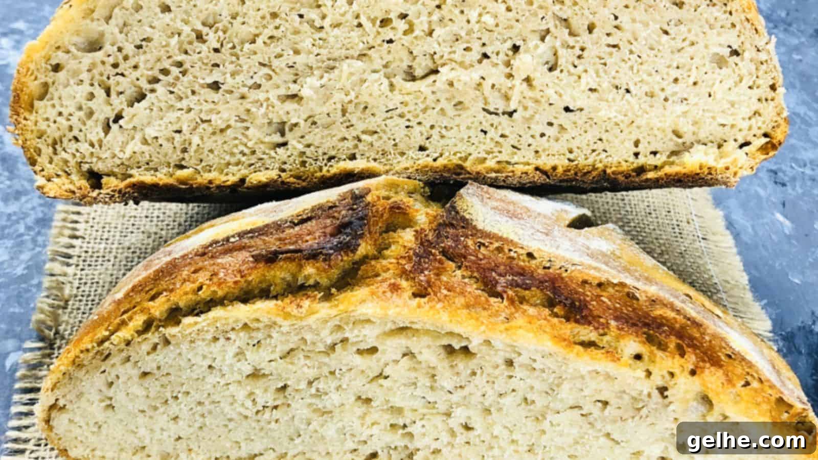 A close-up of a loaf of bread cut in half, displaying the crumb texture and crust details with one half resting above the other.