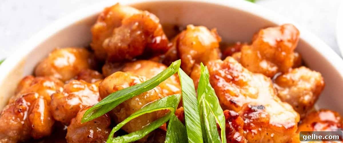 Honey butter chicken with garnish.