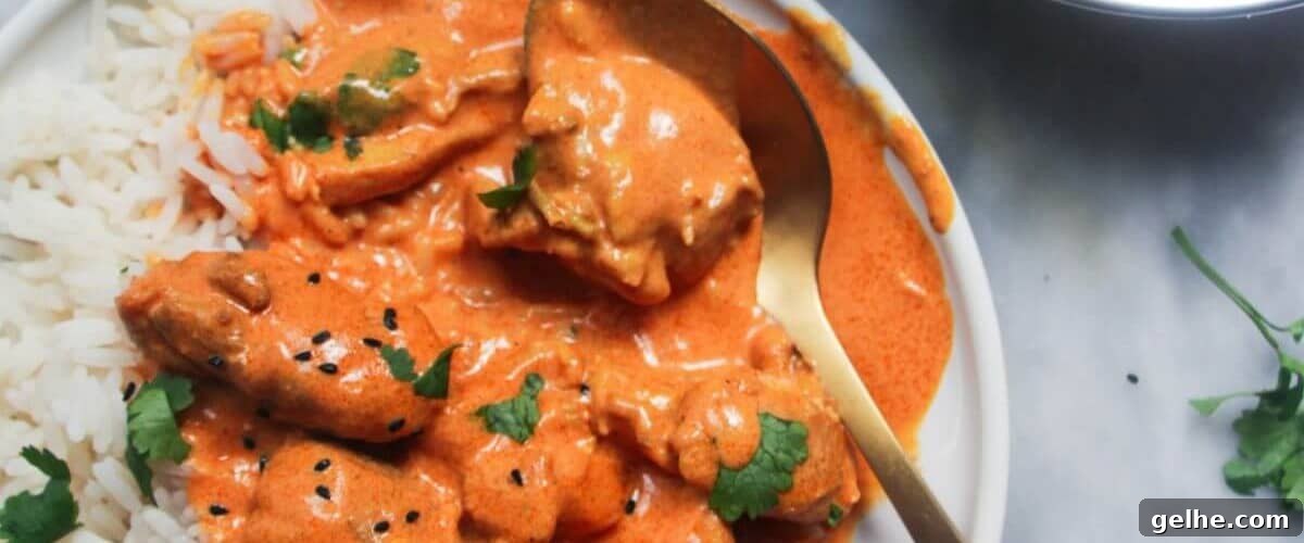 New Zealand style butter chicken in white dish with garnish.