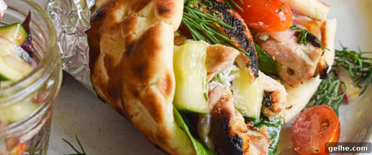 Greek chicken gyros with garnish and veggies.