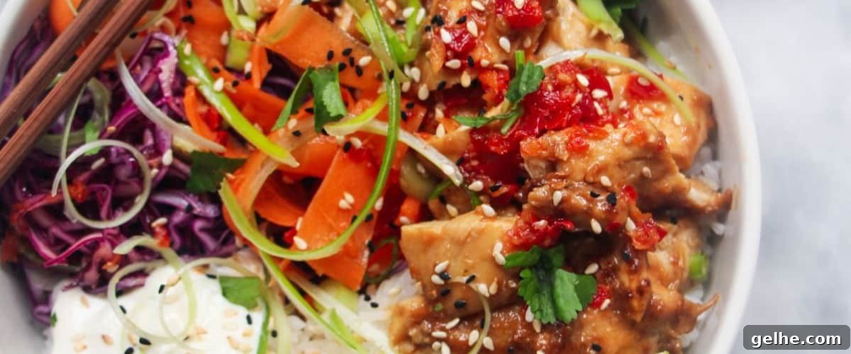 Grilled chicken poke in white bowl with garnish.