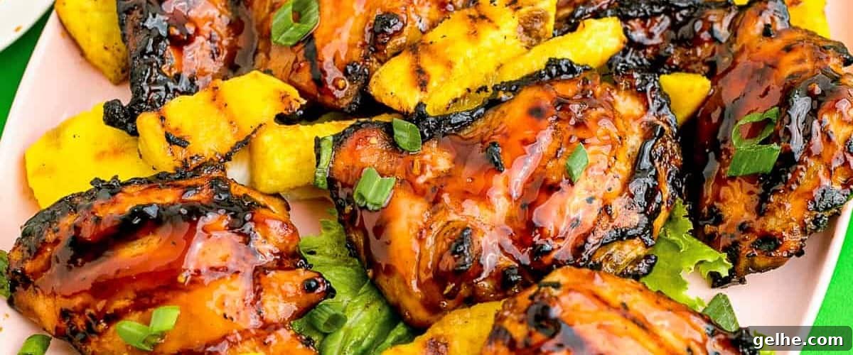Huli huli chicken with pineapple and garnish.