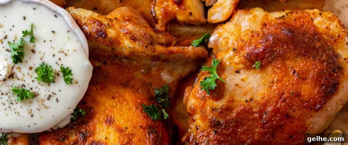 Baked buffalo chicken thighs with garnish.