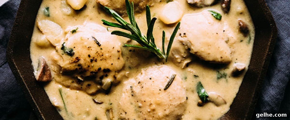 Creamy one pan chicken and potatoes in black dish with garnish.