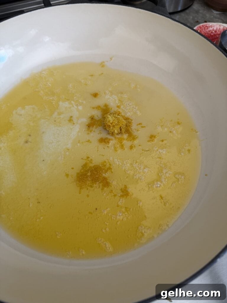 Lemon zest in butter in pan for the lemon pasta with spinach sauce.