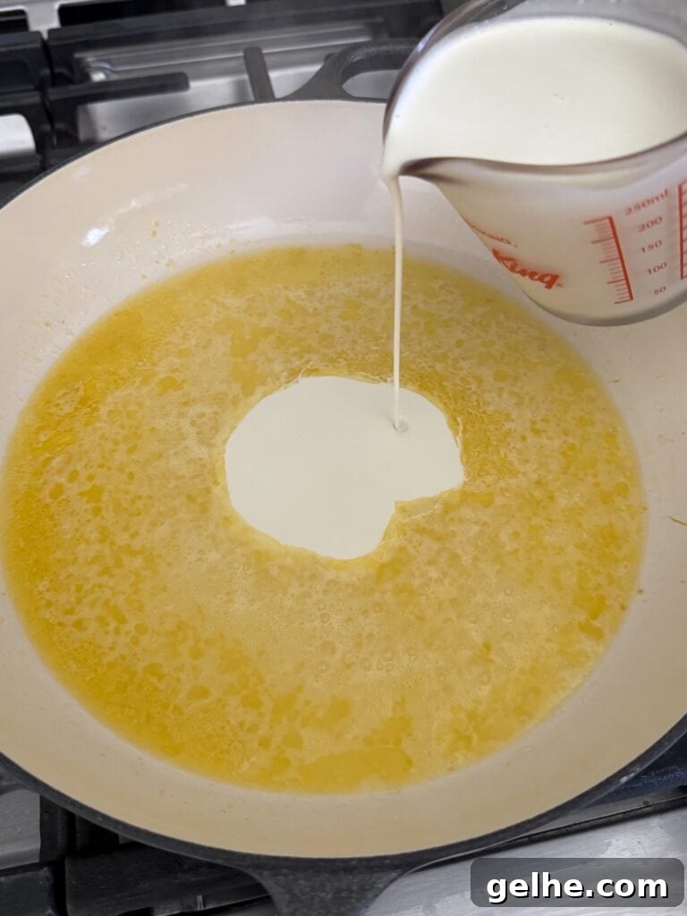 Pouring heavy cream into sauce pan.