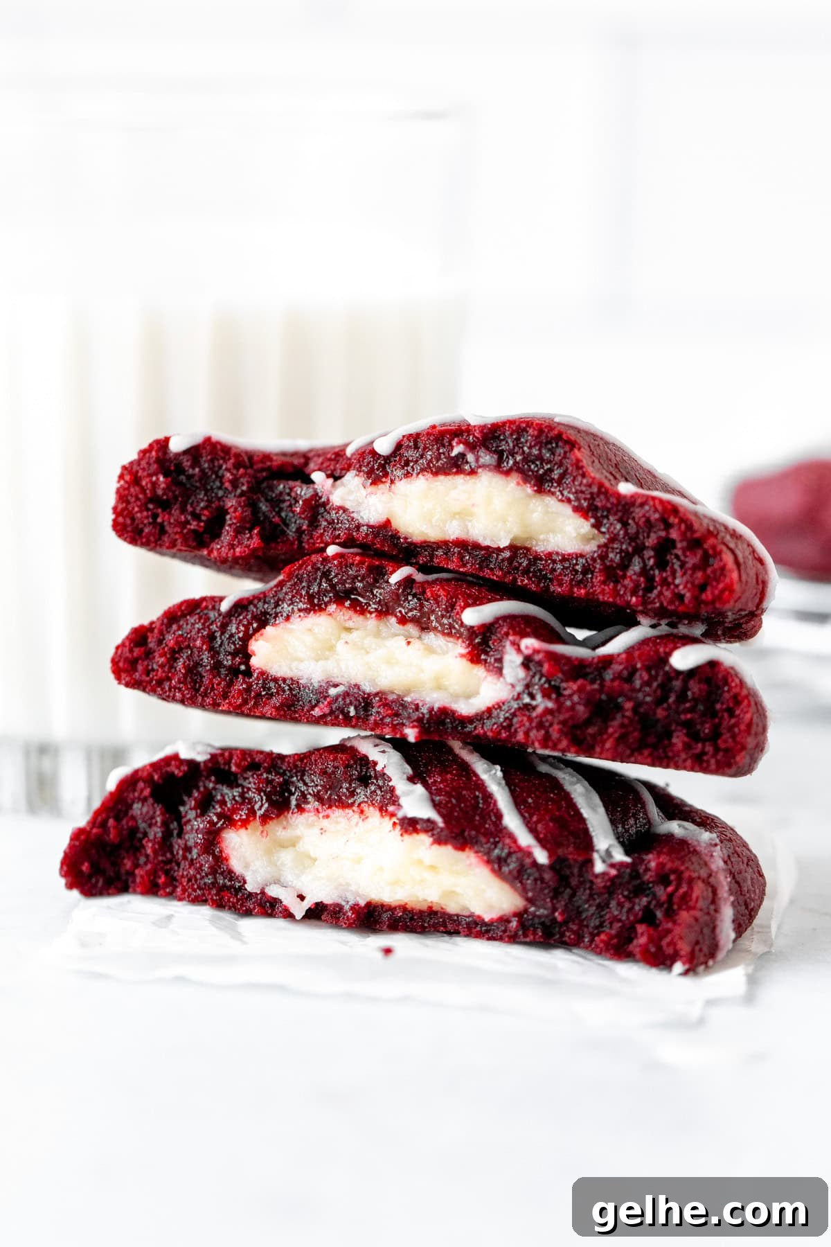 Stack of three half red velvet cheesecake cookies