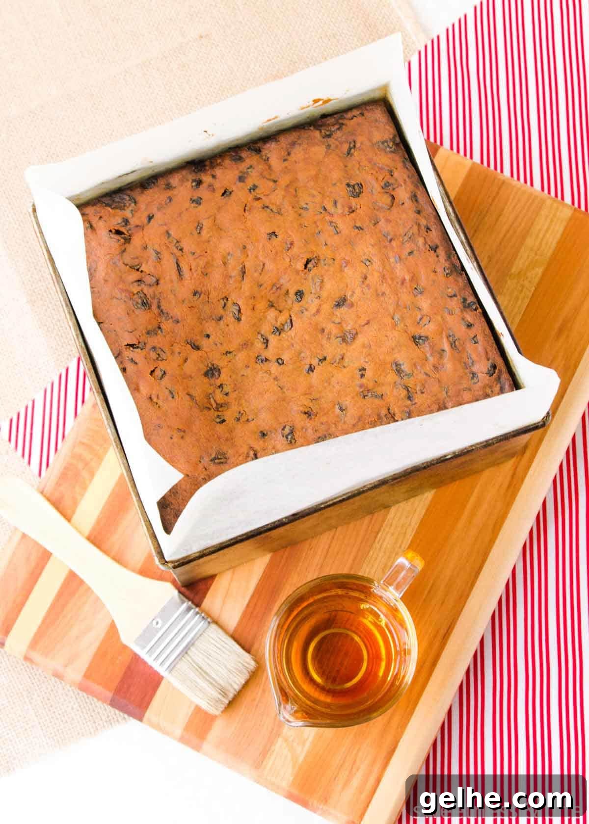 Baked fruit cake about to be brushed with brandy.