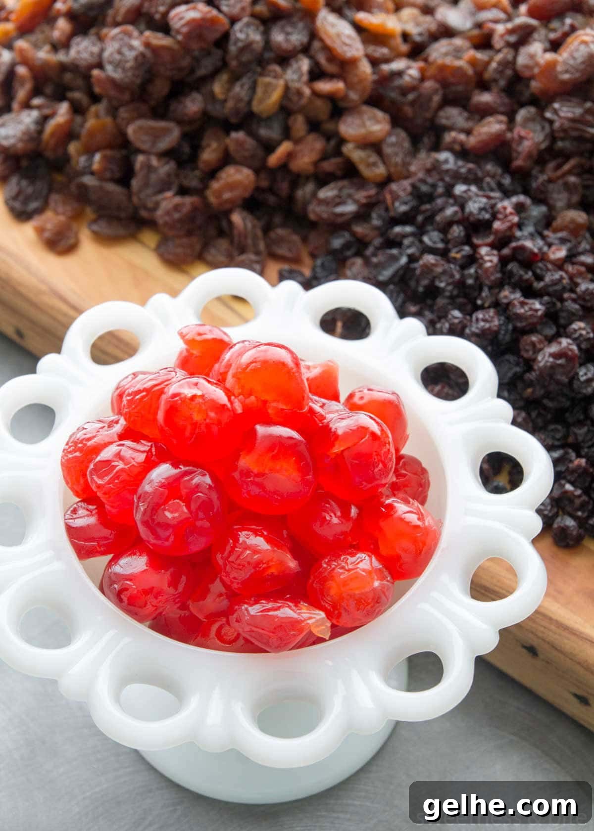 A white bowl of red glacé cherries.