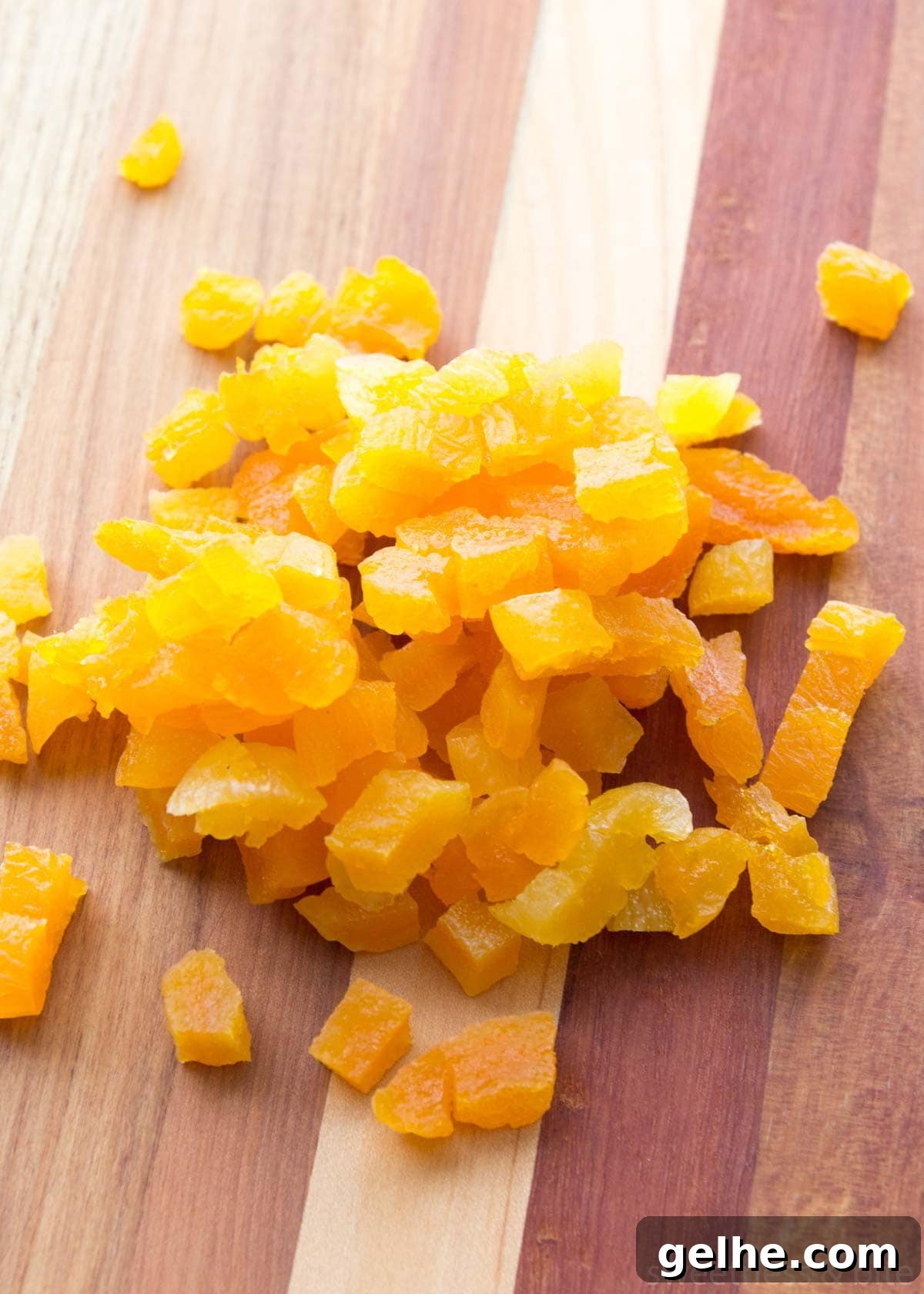 Chopped dried apricots on a wooden board.
