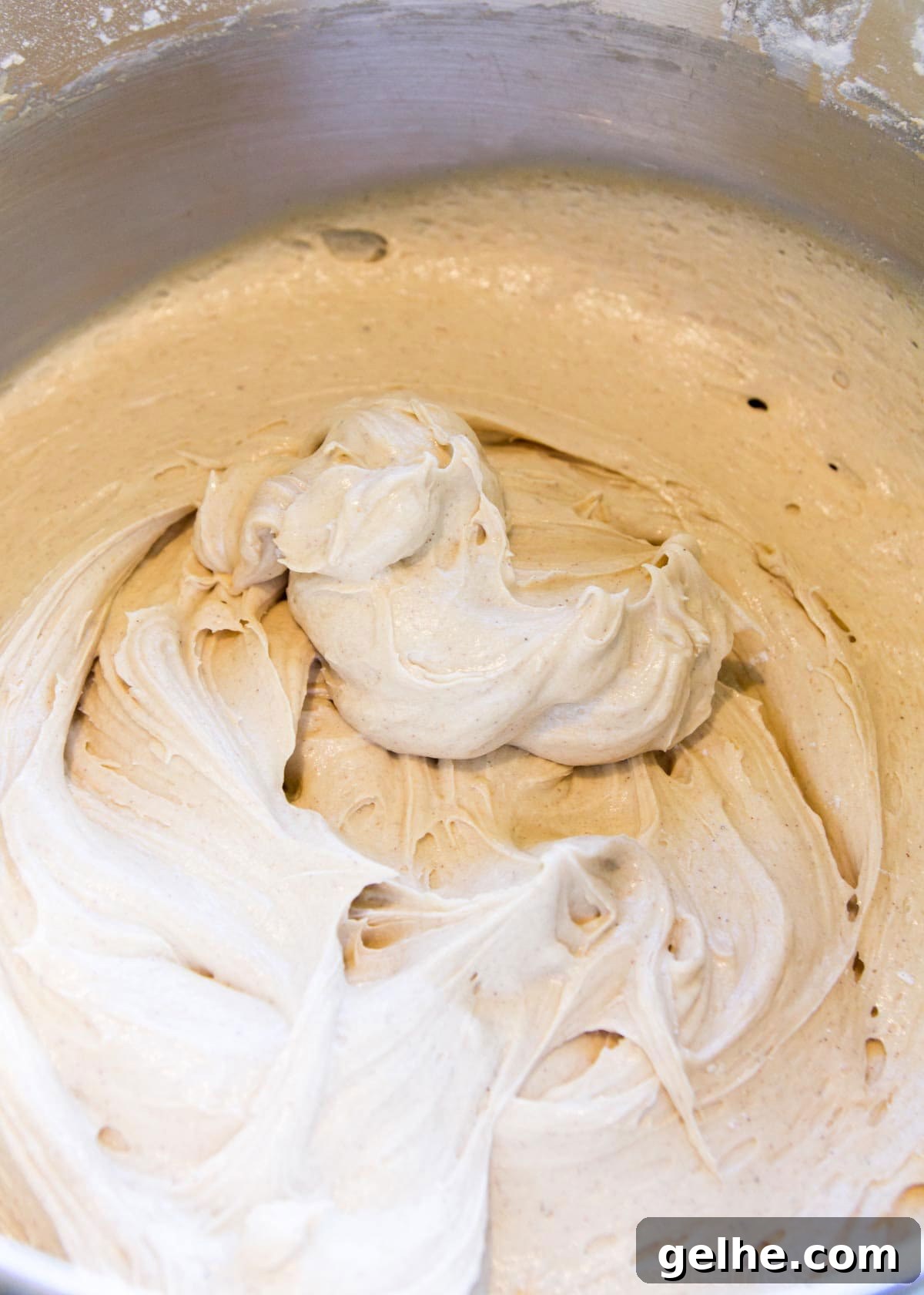 Fruit cake batter in a stainless steel bowl.