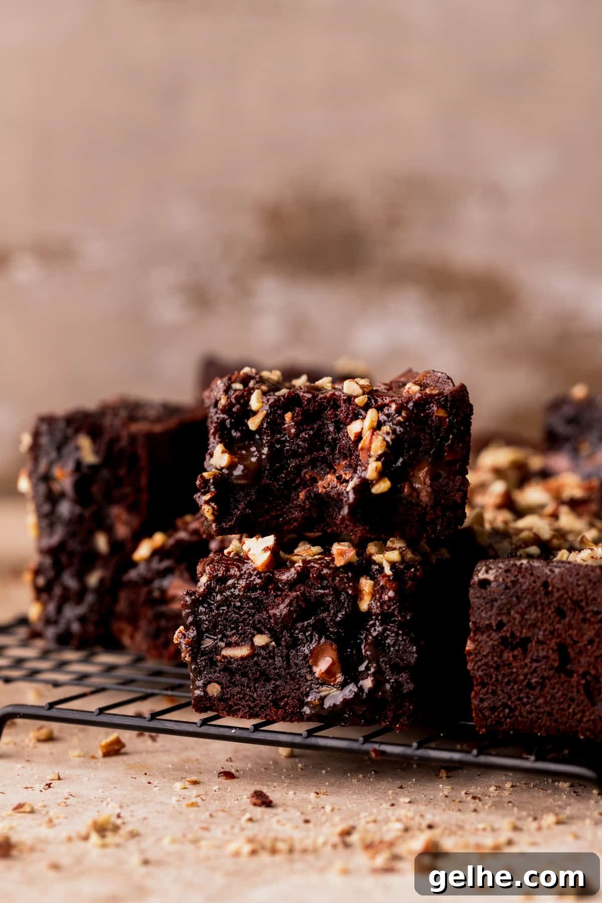Stack of two turtle brownies on a wire rack.