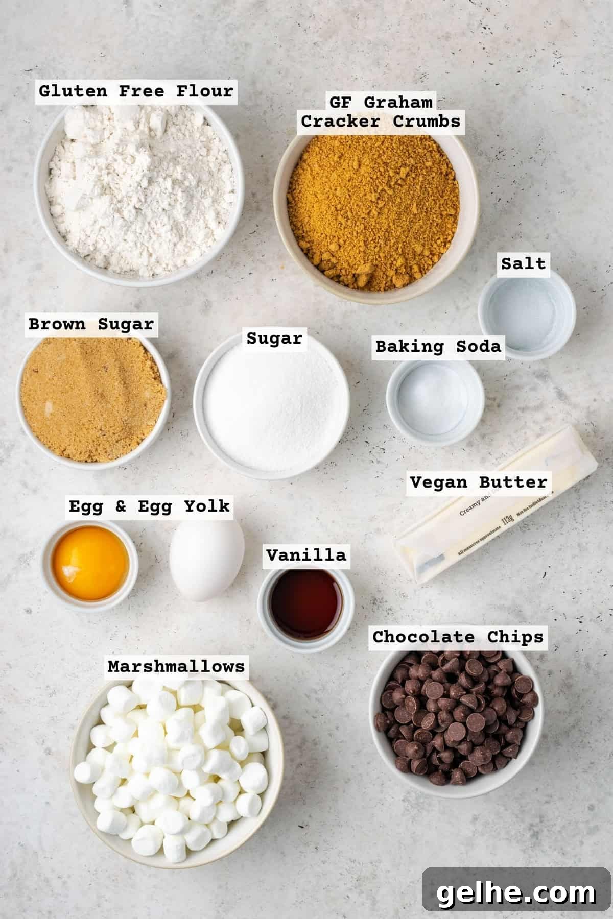 Ingredients for gluten free smores chocolate chip cookies on a white table.