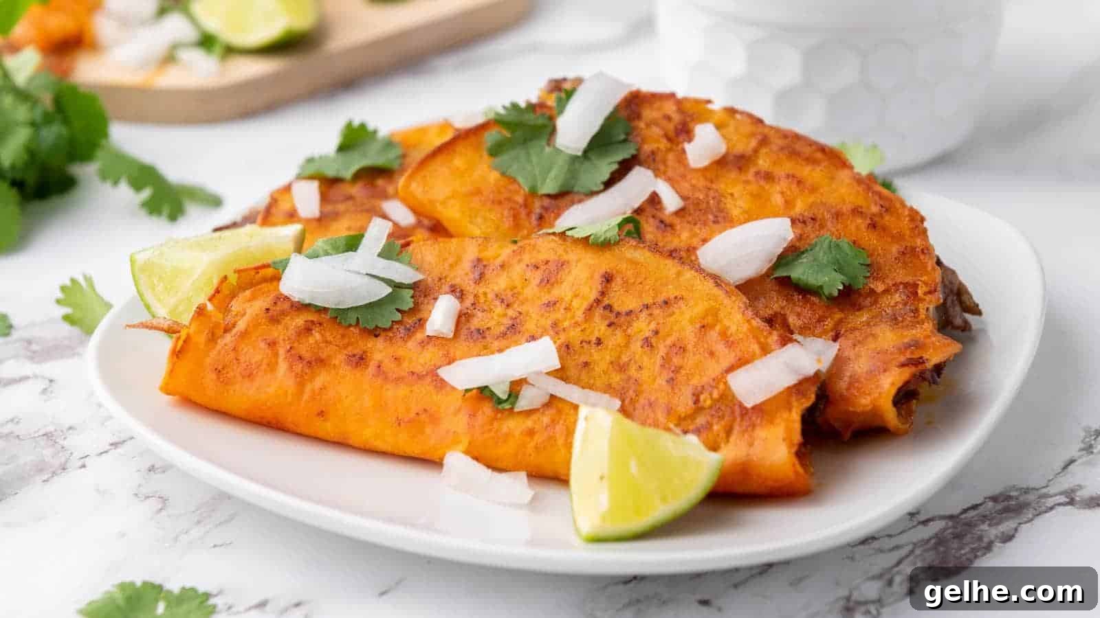 21 Labor Day Picnic Recipes for a Crowd: Ultimate Menu Ideas 14 Quesabirria tacos garnished with chopped onions, cilantro, and lime wedges are served on a white plate.
