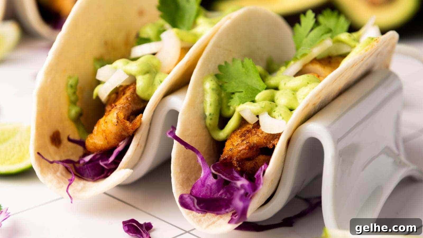 21 Labor Day Picnic Recipes for a Crowd: Ultimate Menu Ideas 4 Two fish tacos filled with grilled fish, shredded purple cabbage, chopped onions, cilantro, and drizzled with a green sauce.