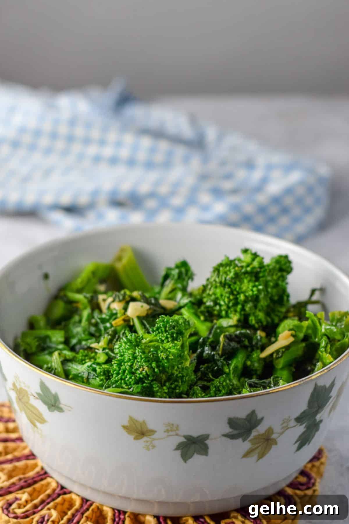 A bowl with leaves on it with the cooked vegetable in it