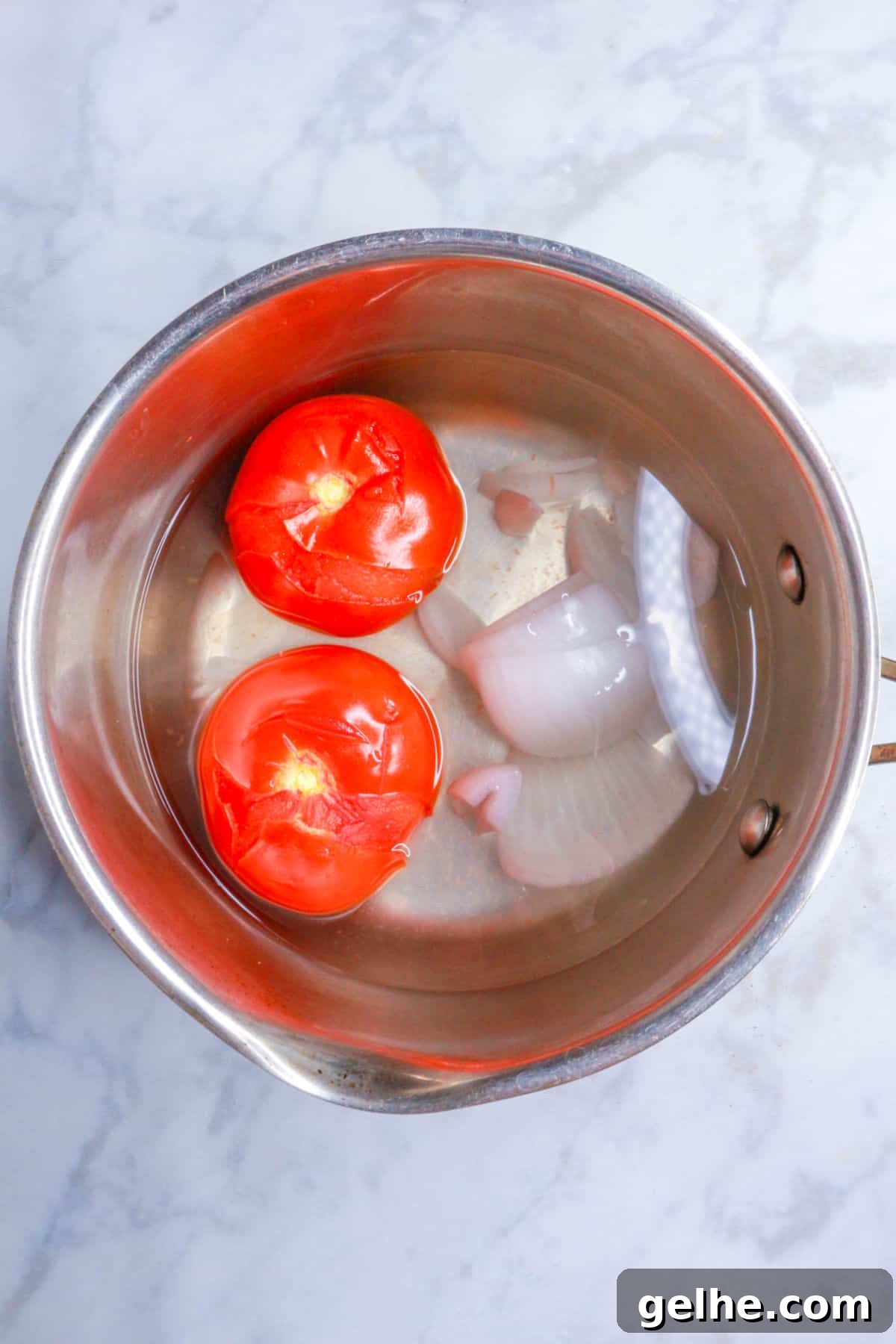 Pot with boiled tomatoes and onion