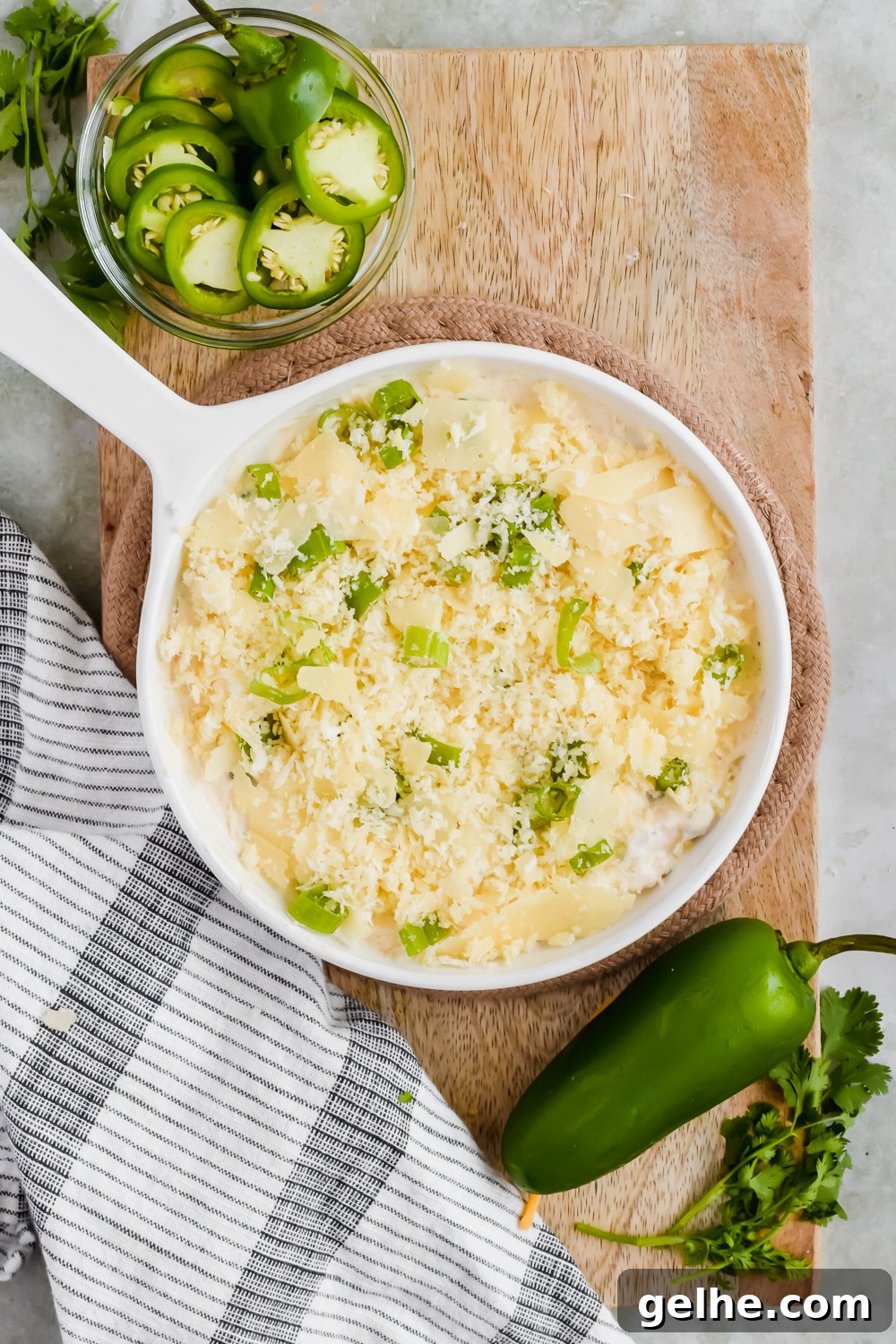 Baked Cheddar Jalapeño Dip with Crispy Panko Topping 5 cheddar jalapeño dip unbaked in white skillet toped with panko, parmesan, and green onion.