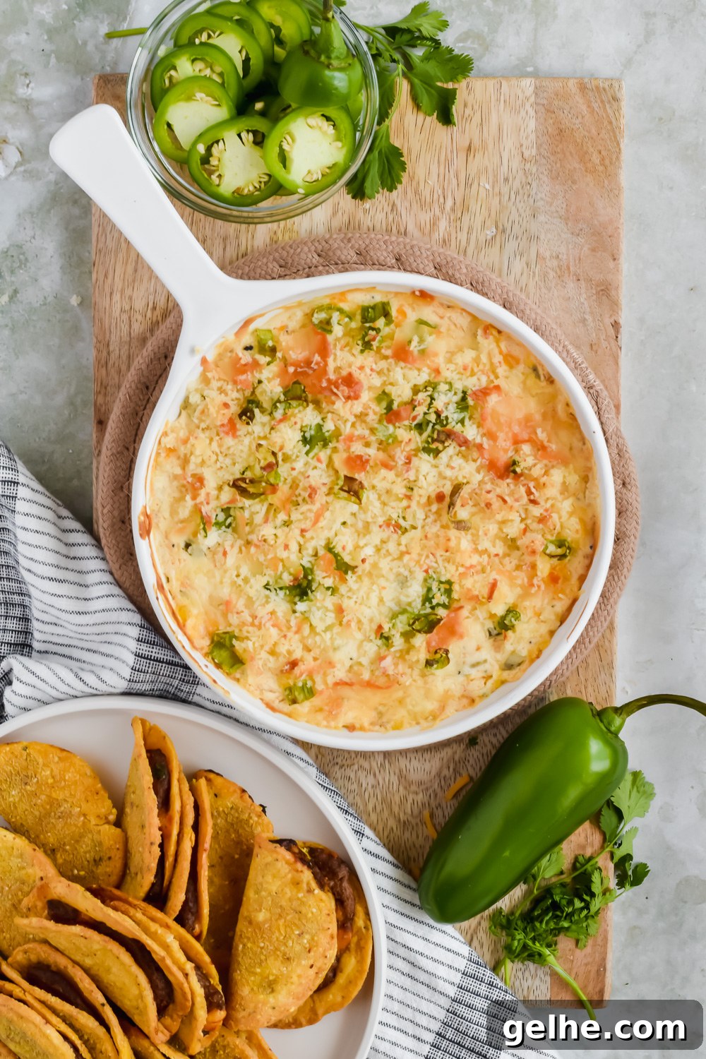Baked Cheddar Jalapeño Dip with Crispy Panko Topping 6 Baked cheddar jalapeño dip in white skillet beside plate of tortilla chips.