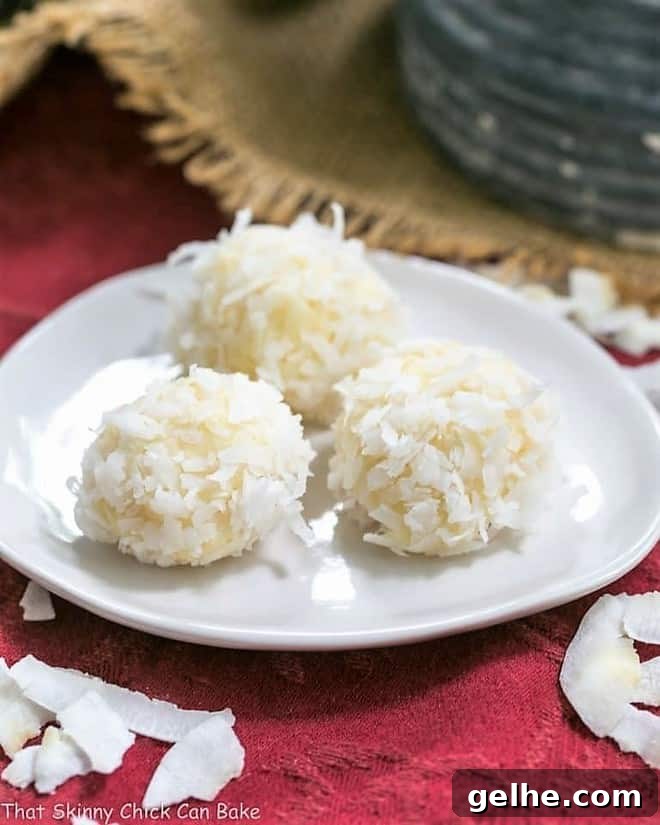 Coconut White Chocolate Truffles on an oval white plate.