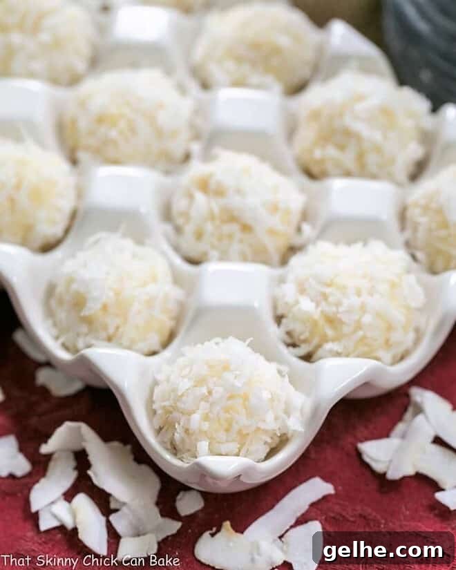Close view of Coconut White Chocolate Truffles in a ceramic egg crate.